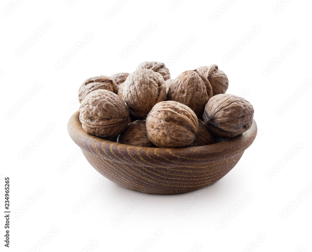 Heap of walnuts isolated on white background. Walnut in a wooden bowl on white background. Walnuts with copy space for text. Heap of walnuts isolated on white background. Walnut in a wooden bowl on white background. Walnuts with copy space for text.