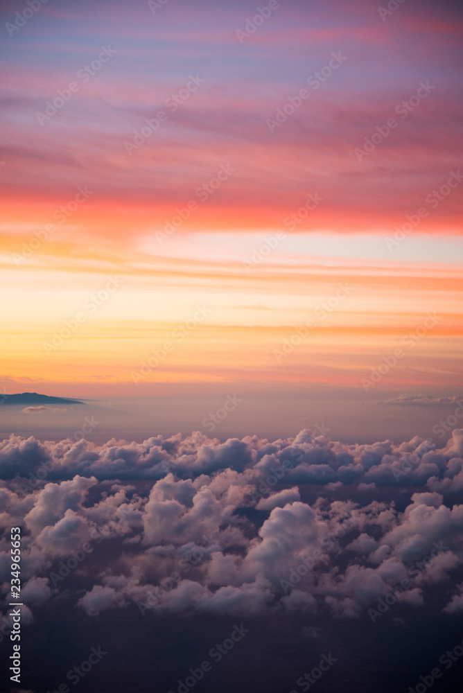 Beautiful Cloudscape Photo Colorful Sunset Sky at Dusk from the Top of Haleakala Volcano in Maui Hawaii with Mountains in Background of Amazing Landscape in Island Paradise