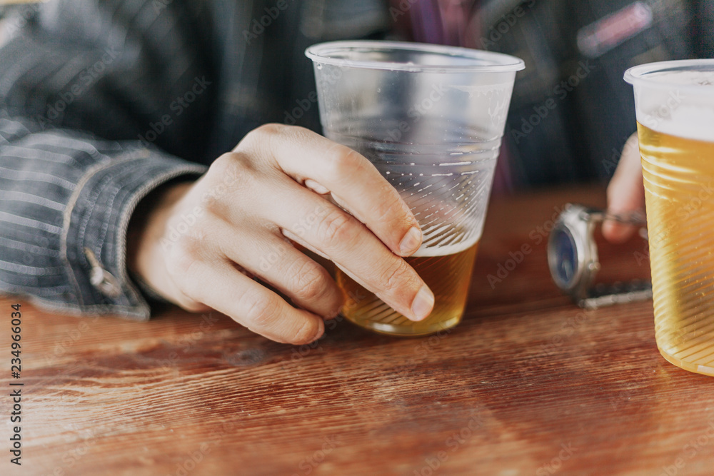 man hand holds an incomplete glass of beer man hand holds an incomplete glass of beer