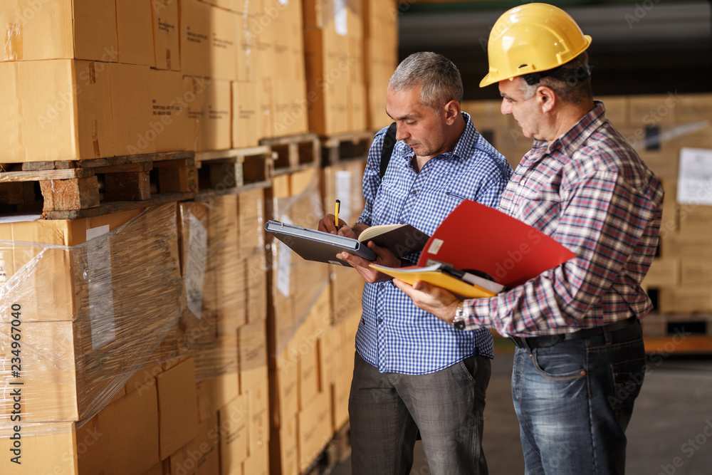 Manager and warehouse worker checking list and inventory on the shelf in storehouse. Manager and warehouse worker checking list and inventory on the shelf in storehouse.