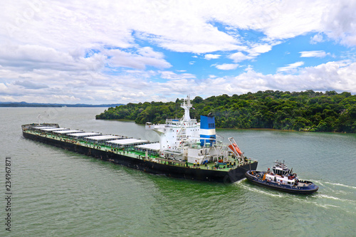 Cargo Ship and Tug Boat at Lake Gatun  Panama Canal  Panama. Central America Man made Lake