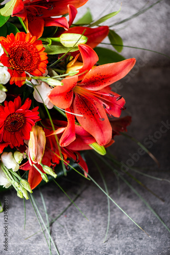 Vibrant Bouquet of orange Asiatic lilies and other flowers photo