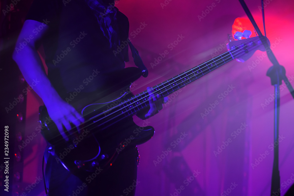 Fototapeta premium Electric bass guitar player on a stage