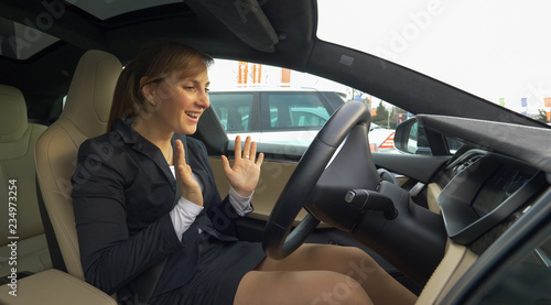 CLOSE UP: Young businesswoman is amazed at the high tech car parking itself. © helivideo