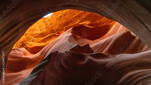 Yellow orange Sandstone cliff through a brown tunnel in Lower Antelope, Arizona