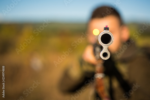 Hunter with shotgun gun on hunt. Barrel of a gun. Track down. Copy space for text. Hunting gun.