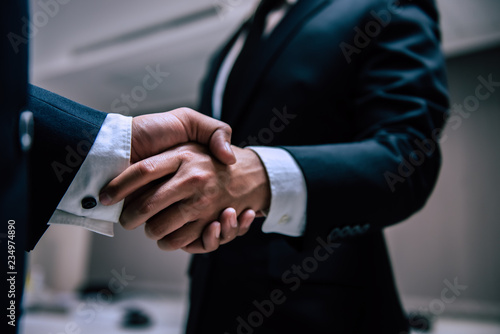 Business people shaking hands, finishing up a meeting,Negotiations were successfully © reewungjunerr