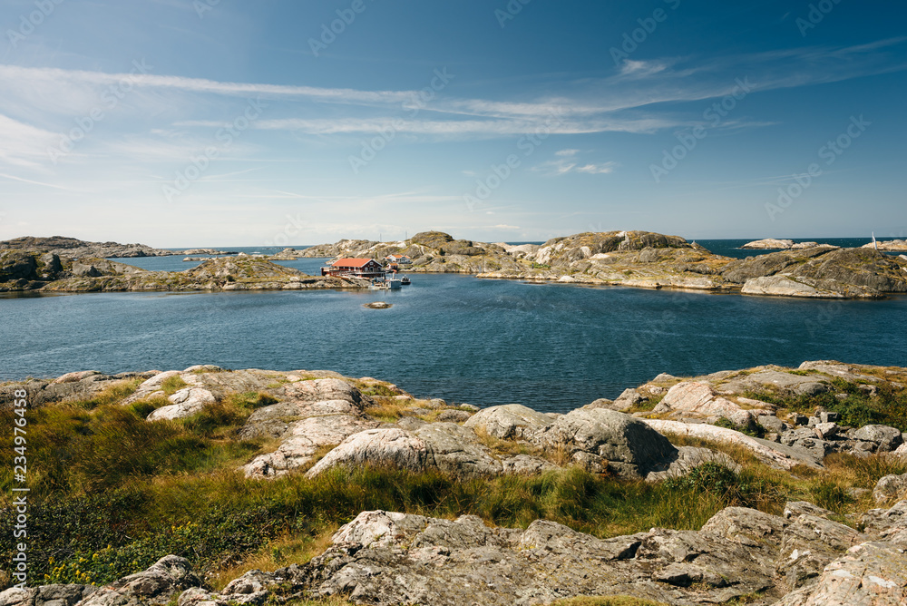 Sea landscape of a rocky coastline and a small town on the South of Sweden.