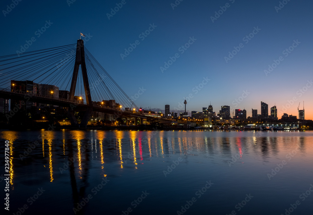 ANZAC Bridge and Sydney city skyline at dawn