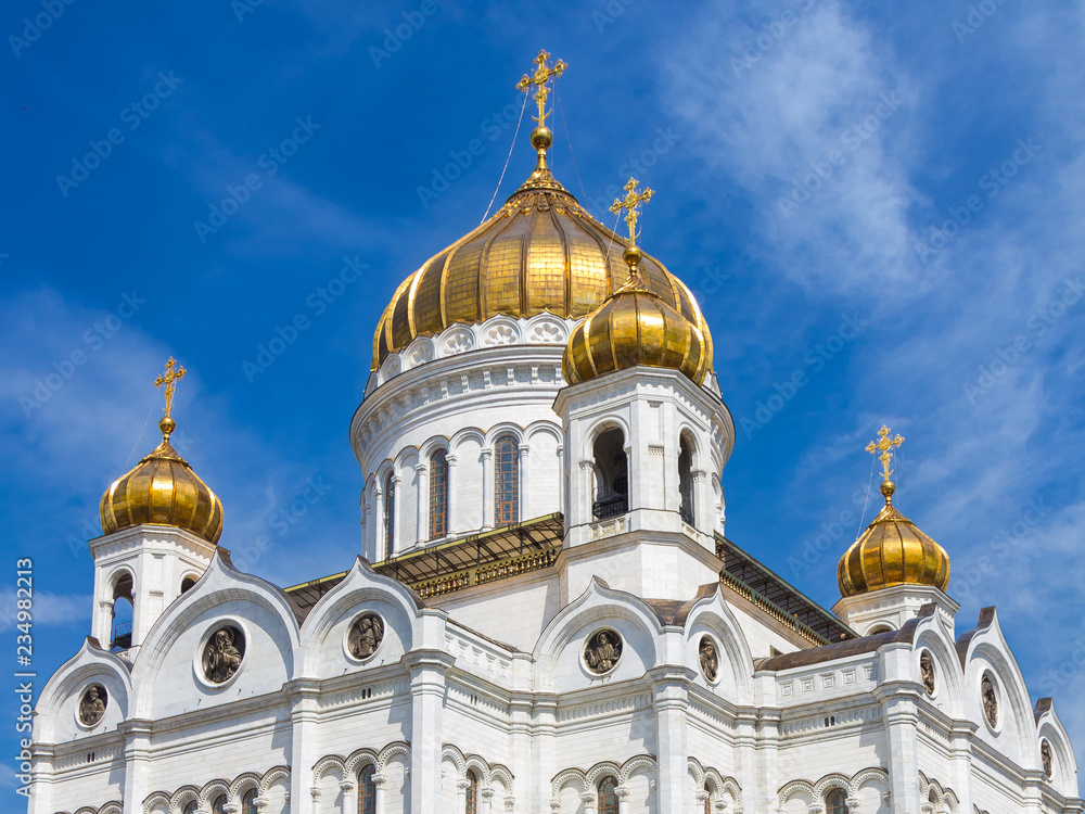 View of the Cathedral of Christ the Saviour in Moscow in spring sunny day. Around lilac trees blossom