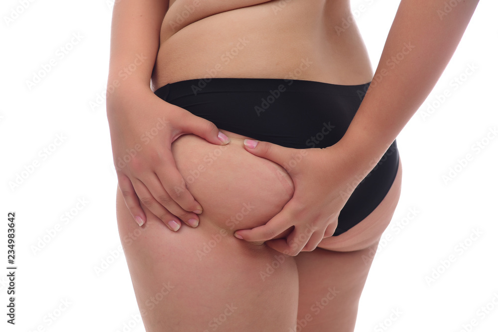 young woman pinching fat on her buttocks on white background young woman pinching fat on her buttocks on white background