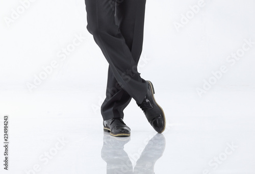 crossed legs of business man in pants and shoes.isolated on white
