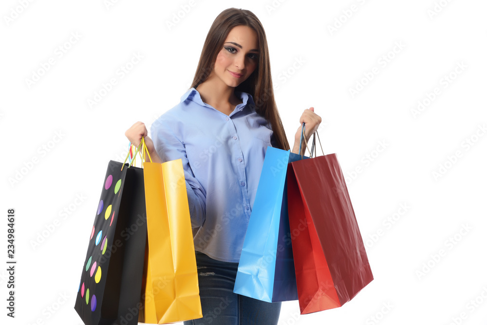 Shopping and Lifestyle Concept: Young cheerful woman holding colorful shopping bag