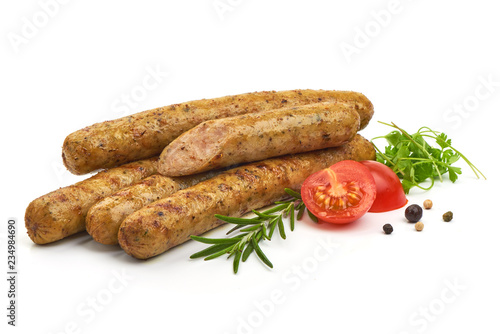 Grilled German Thin Sausages with herbs, pepper and tomatoes, isolated on a white background. Close-up