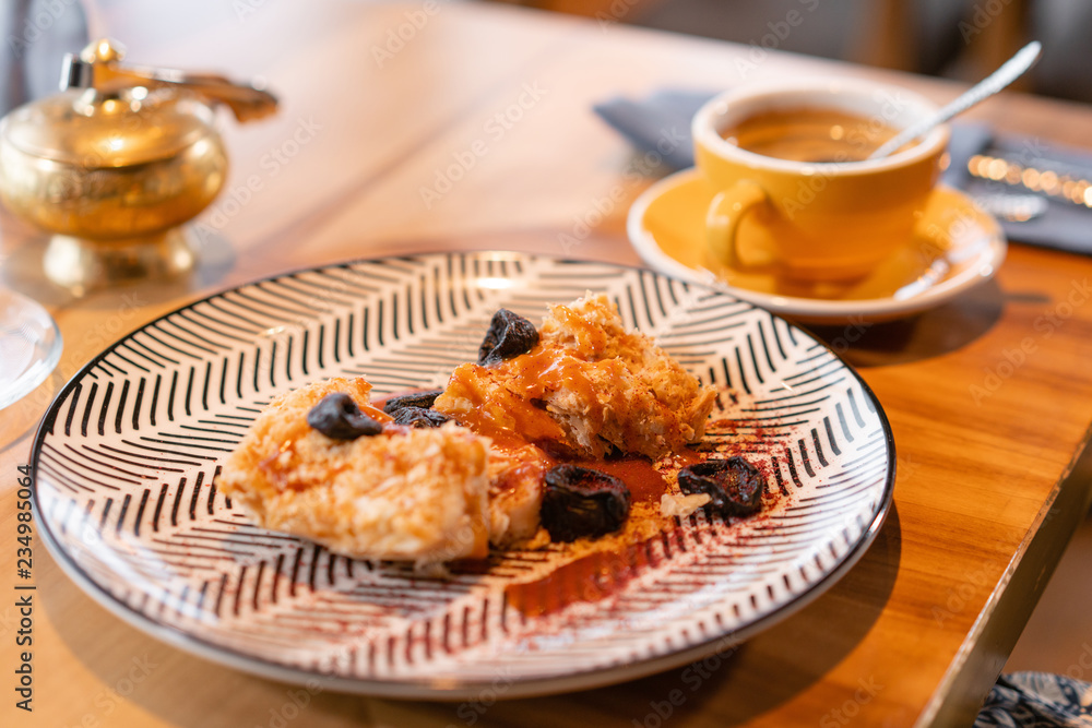 Napoleon dessert with salted caramel and prunes, in the original serving. Breakfast, pleasant morning, the beginning of the working day Napoleon dessert with salted caramel and prunes, in the original serving. Breakfast, pleasant morning, the beginning of the working day