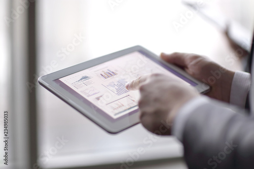 close up.businessman analyzing financial data using digital tab