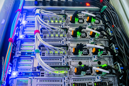 Powerful server equipment is installed in the datacenter rack. Modern high-speedInternet connection of network interfaces. Technical hosting site of a large Internet provider.