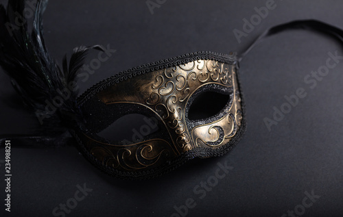 Carnival mask on black background, top view