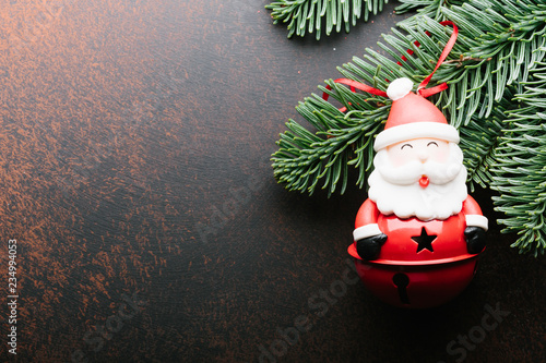 Christmas New Year holiday background. Santa Claus on a branch tree on dark background