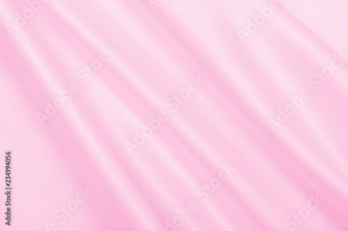 Smooth elegant pink silk or satin texture as wedding background. Luxurious background design