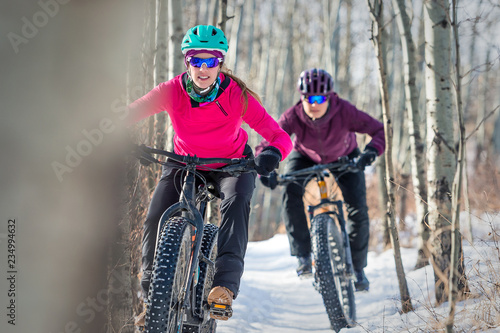 Two Women riding Fat Bikes in the Snow