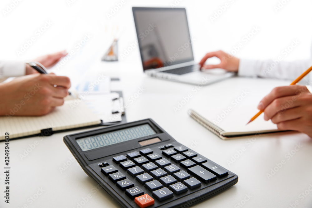 Business team two colleagues discussing new plan financial graph data on office table Business team two colleagues discussing new plan financial graph data on office table