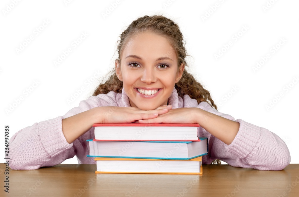 Friendly Young Girl Sitting Behind a Desk with a Books - Friendly Young Girl Sitting Behind a Desk with a Books -