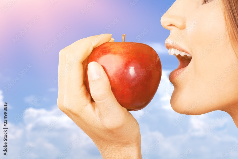 Young woman holding fresh apple on white background Young woman holding fresh apple on white background