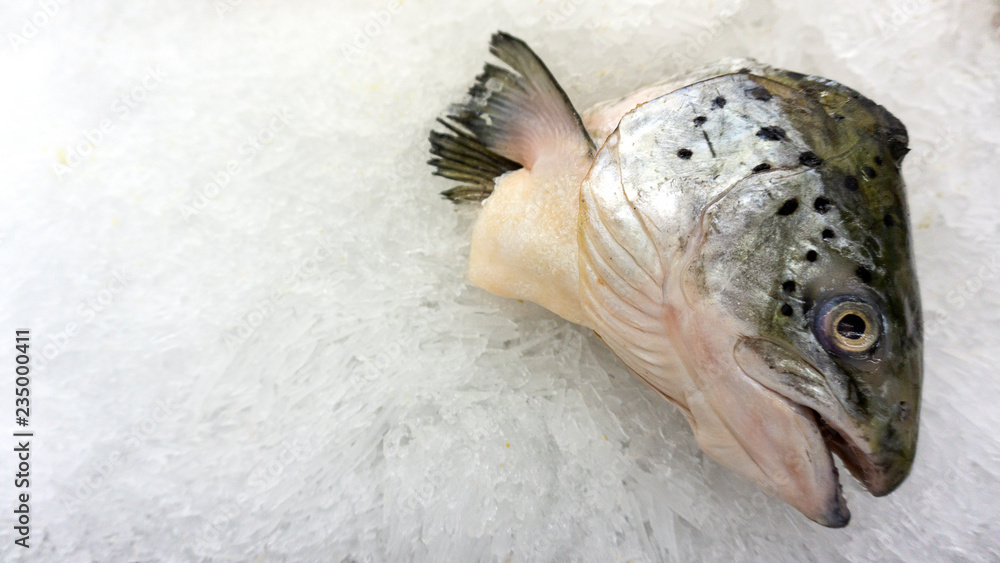 Salmon head fish raw on ice sold in supermarkets. Seafood in the shop window. Buy for cooking. food concept. Top view, copy space.