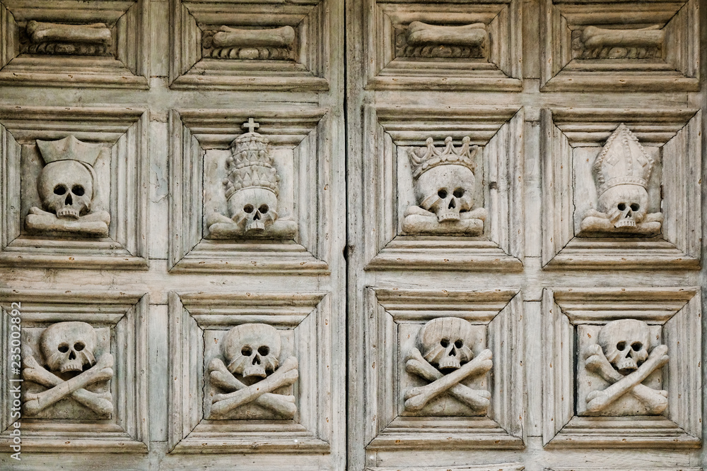 Sassi di Matera. The old door to the church is decorated with crossbone skulls.