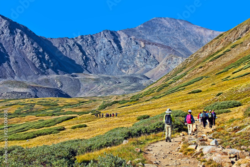 Hikers start out for the summit of Colorado's 14,000-foot Gray's Peak (in background) photo