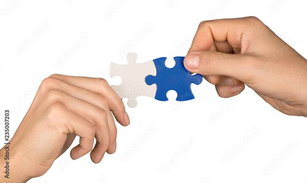 Closeup on Hands Combining Puzzle Pieces Together Closeup on Hands Combining Puzzle Pieces Together