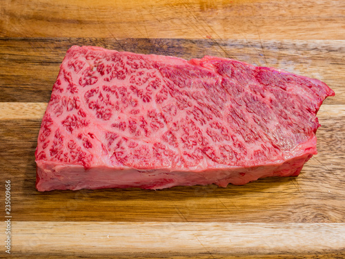 Raw Wagyu beef sit on a board