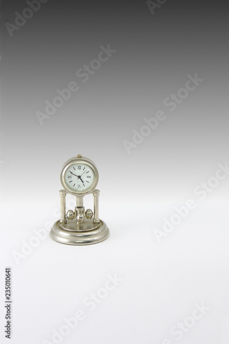 Miniature clock on gradient background