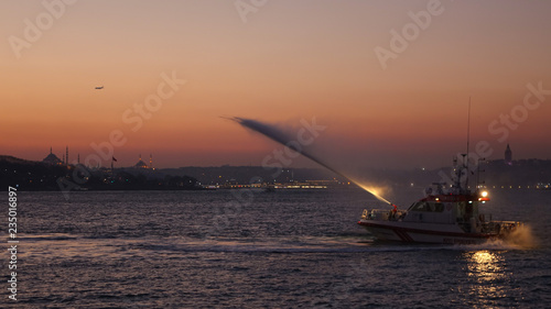 Fireboat spraying water on the Bosporus strai in Istanbul, Turkey. photo