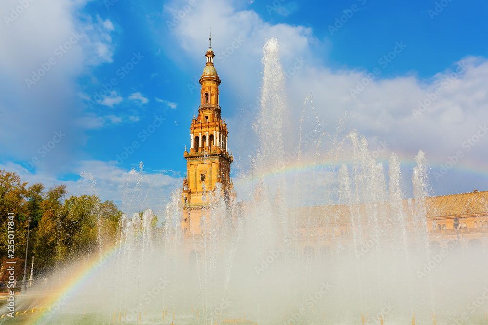 rainbow in a fountain in front of the palace of the Plaza de Espana in Seville, Spain