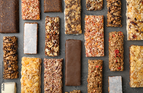 Flat lay composition with protein bars on grey background