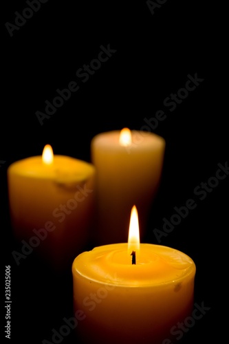 Close-Up of Three Lit Candles on Black Background
