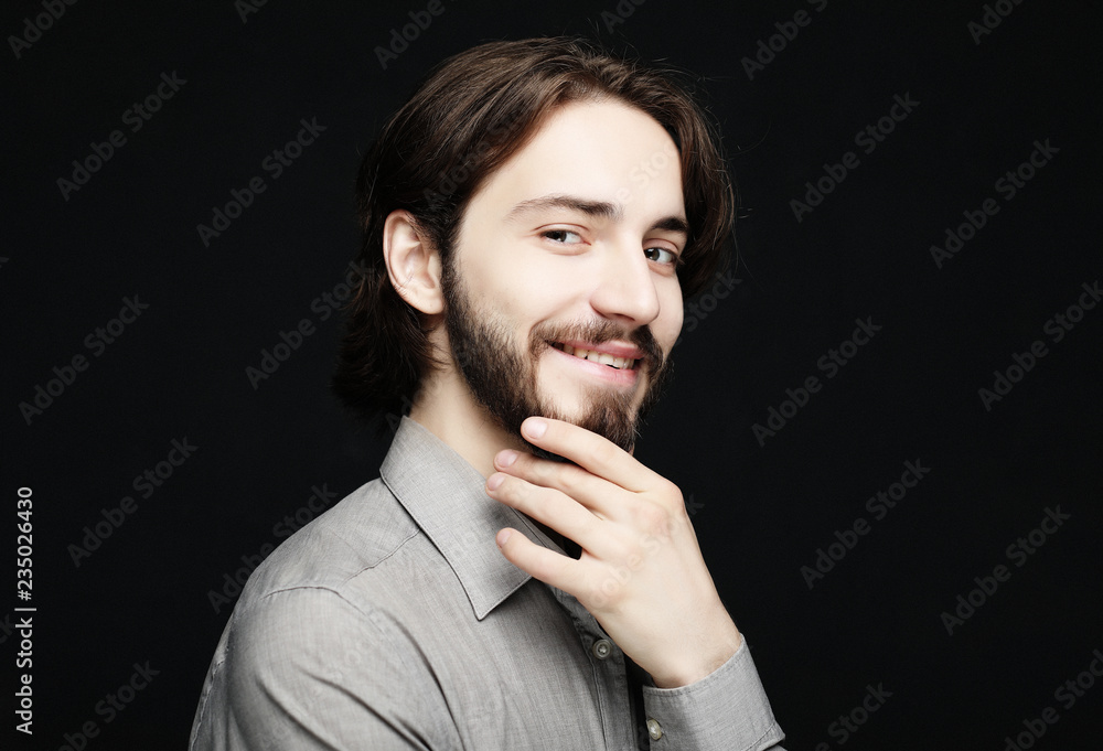 lifestyle and people concept: Portrait of handsome young man with smile on dark background lifestyle and people concept: Portrait of handsome young man with smile on dark background