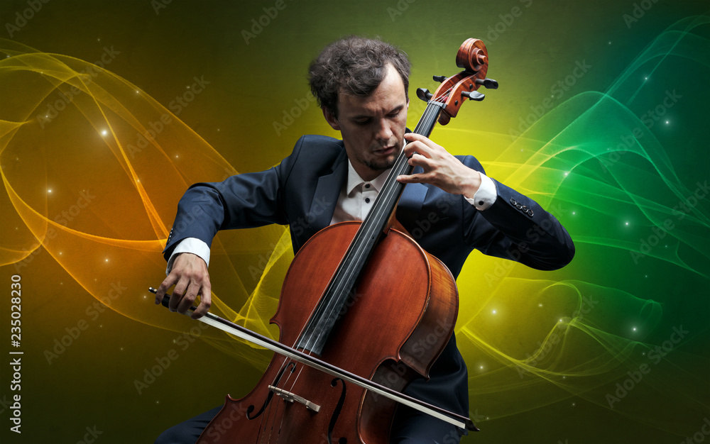 Fototapeta premium Serious classical cellist with fabled sparkling wallpaper