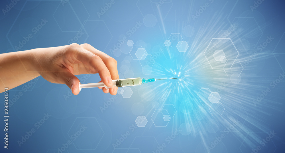 Female doctor hand holding syringe with shiny background Female doctor hand holding syringe with shiny background