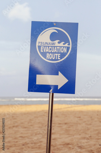 Tsunami evacuation way sign on the tropical island