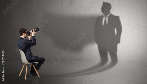 Canvas Print Humble businessman staying and offering stuffs to a huge angry bull shadow