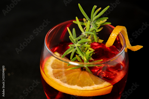 Gotfather cocktail with bourbon whiskey, amaretto, orange wedge and rosemary photo