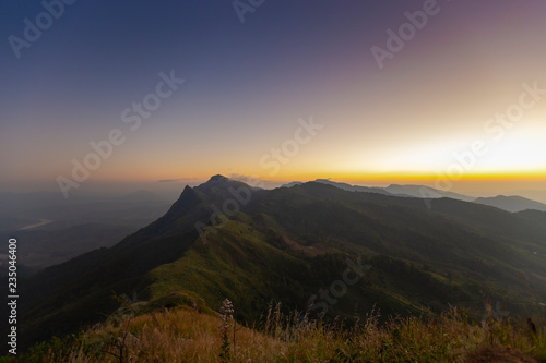Mountains with spotted sunset at Doi Pha Tang, Chiang Rai, Thailand.