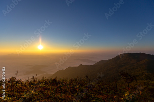 Sun rise at Phu Chi Duen is a mountain area and national forest park in Thailand. It is located at the northeastern end of the Phi Pan Nam Range, southwest of Doi Pha Tang. Chiang Rai