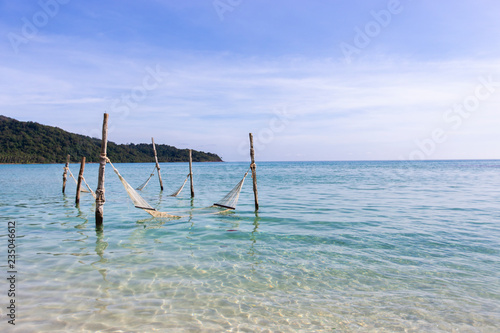 Beautiful blue sea and clear sky. With a hammock in the sea