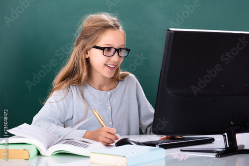 Girl Using Computer In Classroom