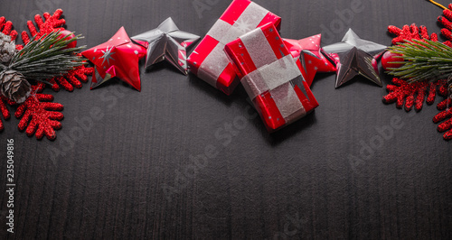 christmas background with decorations and gift boxes on wooden board