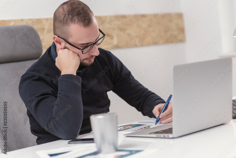young businessman working in his office. business concept young businessman working in his office. business concept